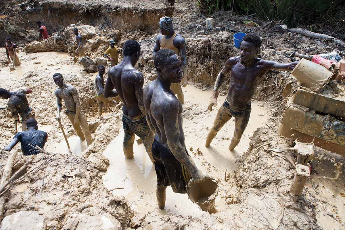 Men work in an open-pit illegal gold mine in western Ghana.