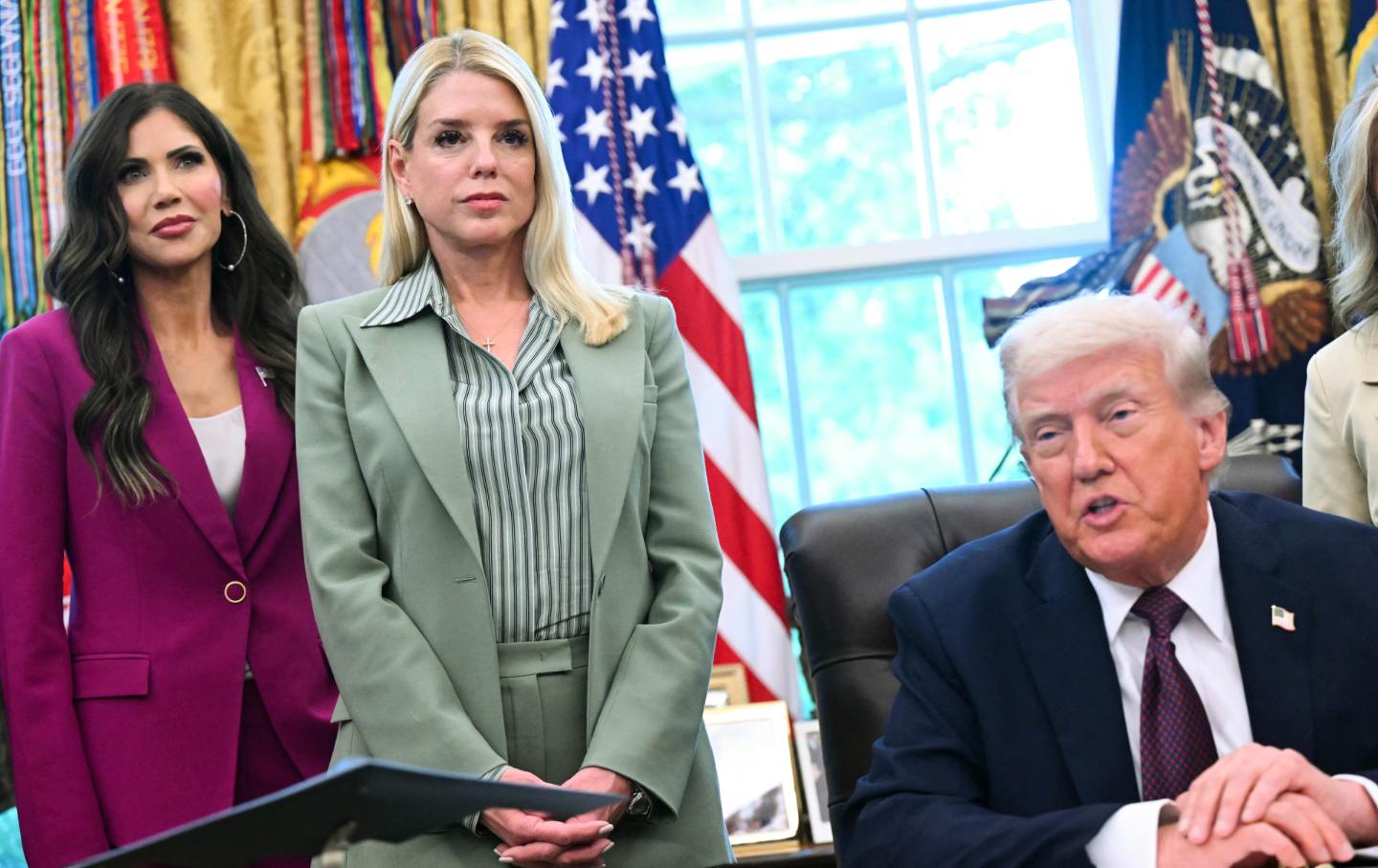 US Secretary of Homeland Security Kristi Noem and US Attorney General Pam Bondi look on as US President Donald Trump speaks in the Oval Office of the White House in Washington, DC, on September 15, 2025.