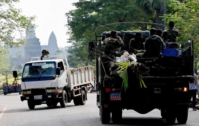 A military truck transporting the belongings of a resident past the Angkor Wat temple in Siem Reap province.