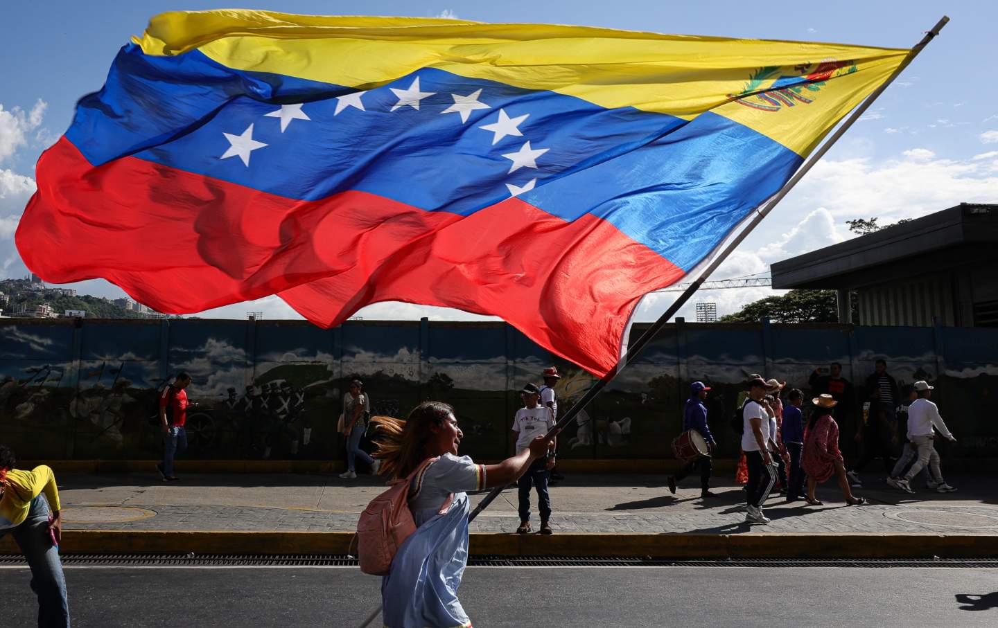 An Indigenous woman waves a Venezuelan flag during a rally to commemorate Indigenous Resistance Day on October 12, 2025 in Caracas, Venezuela.