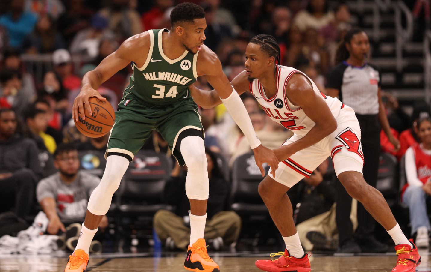Giannis Antetokounmpo #34 of the Milwaukee Bucks is defended by Isaac Okoro #35 of the Chicago Bulls during the second half at the United Center on October 12, 2025 in Chicago, Illinois.