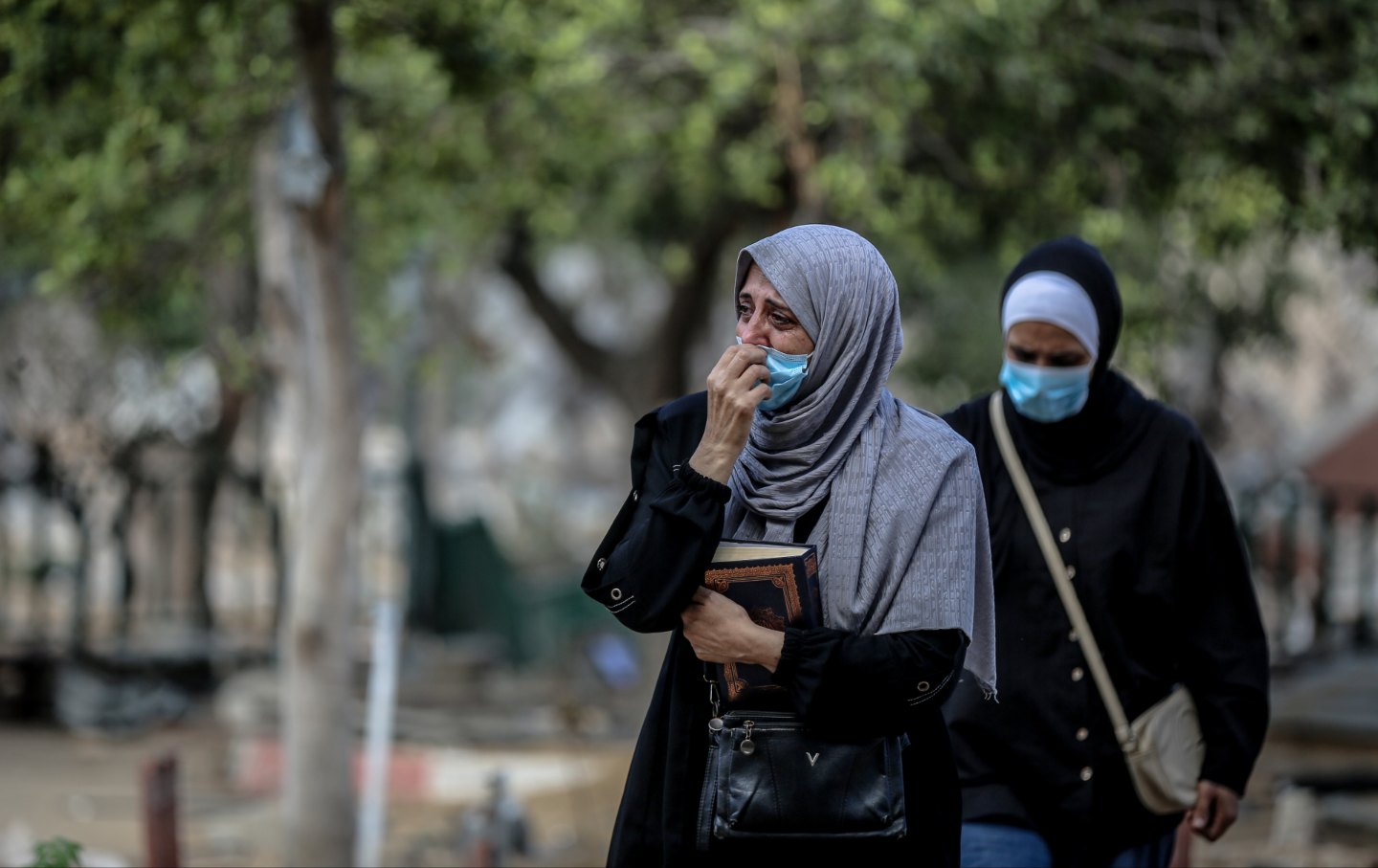 Bodies of Palestinians killed during Israel's two-year-long attacks on the Gaza Strip and buried in temporary graves around Al-Shifa Hospital in Gaza City are being exhumed and reburied in family cemeteries, on October 24, 2025.