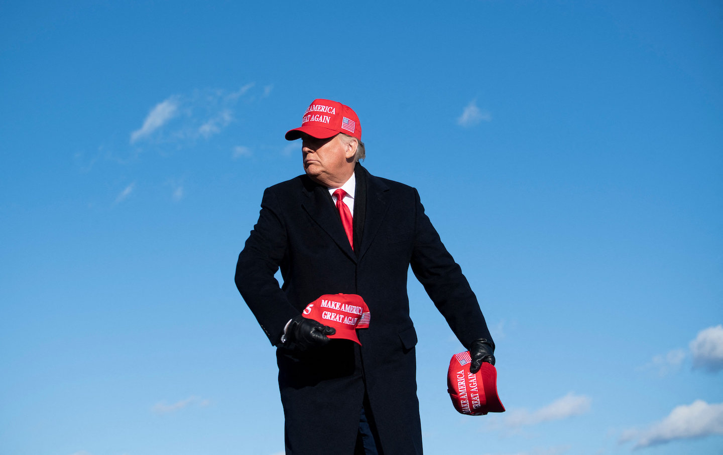 Donald Trump throws hats to supporters during a Make America Great Again rally at Wilkes-Barre Scranton International Airport.