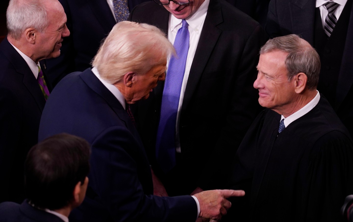 Donald Trump, left, greets John Roberts, chief justice of the US Supreme Court, arrives for a joint session of Congress in the House Chamber of the US Capitol in Washington, DC, US, on Tuesday, March 4, 2025.