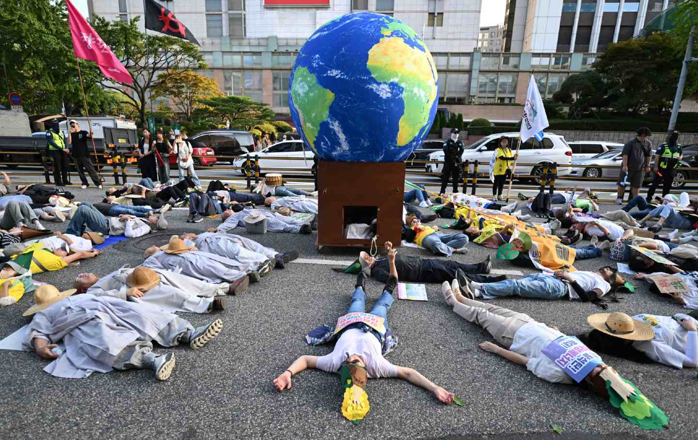 Protesters stage a “die-in” during a rally for Climate Justice in Seoul on September 27, 2025.