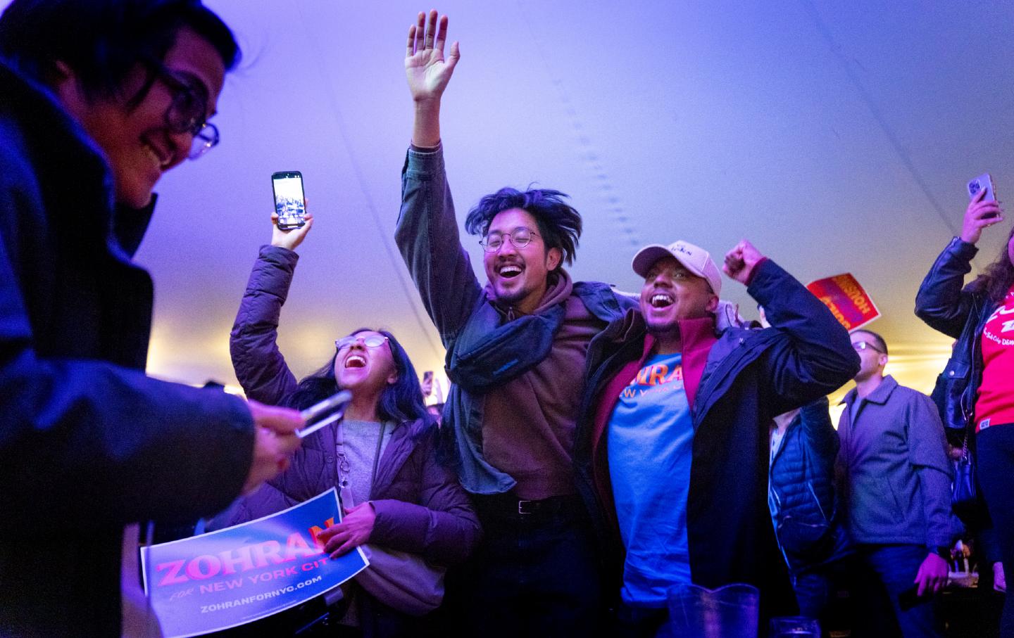 New Yorkers celebrate as NY1 projects Zohran Mamdani the winner in the mayoral election, at the Bohemian Hall & Beer Garden on November 4, 2025 in the Astoria neighborhood of New York City. The watch party was one of many hosted by the Democratic Socialists of America in support of Mamdani.