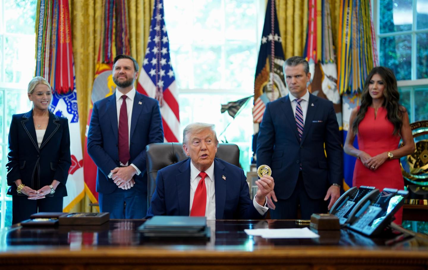Attorney General Pam Bondi, Vice President JD Vance, Defense Secretary Pete Hegseth, and Homeland Security Secretary Kristi Noem flank Donald Trump during an executive order signing in the Oval Office, on August 25, 2025.