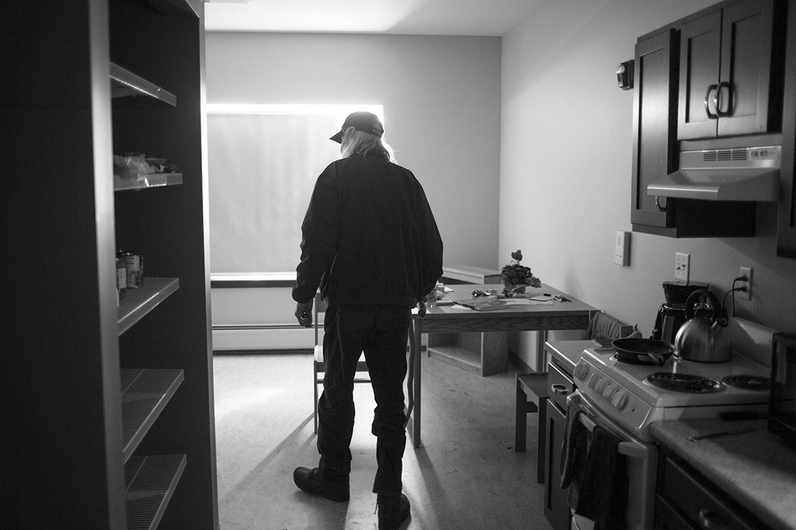 A formerly homeless man stands in his new apartment at Huston Commons, a Housing First program in Portland, Maine.