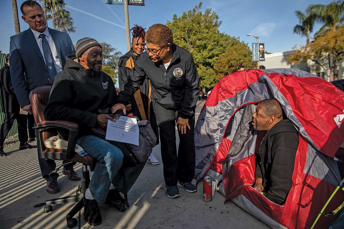 Bass speaks with unhoused people living in tents behind the the Academy Museum of Motion Pictures.