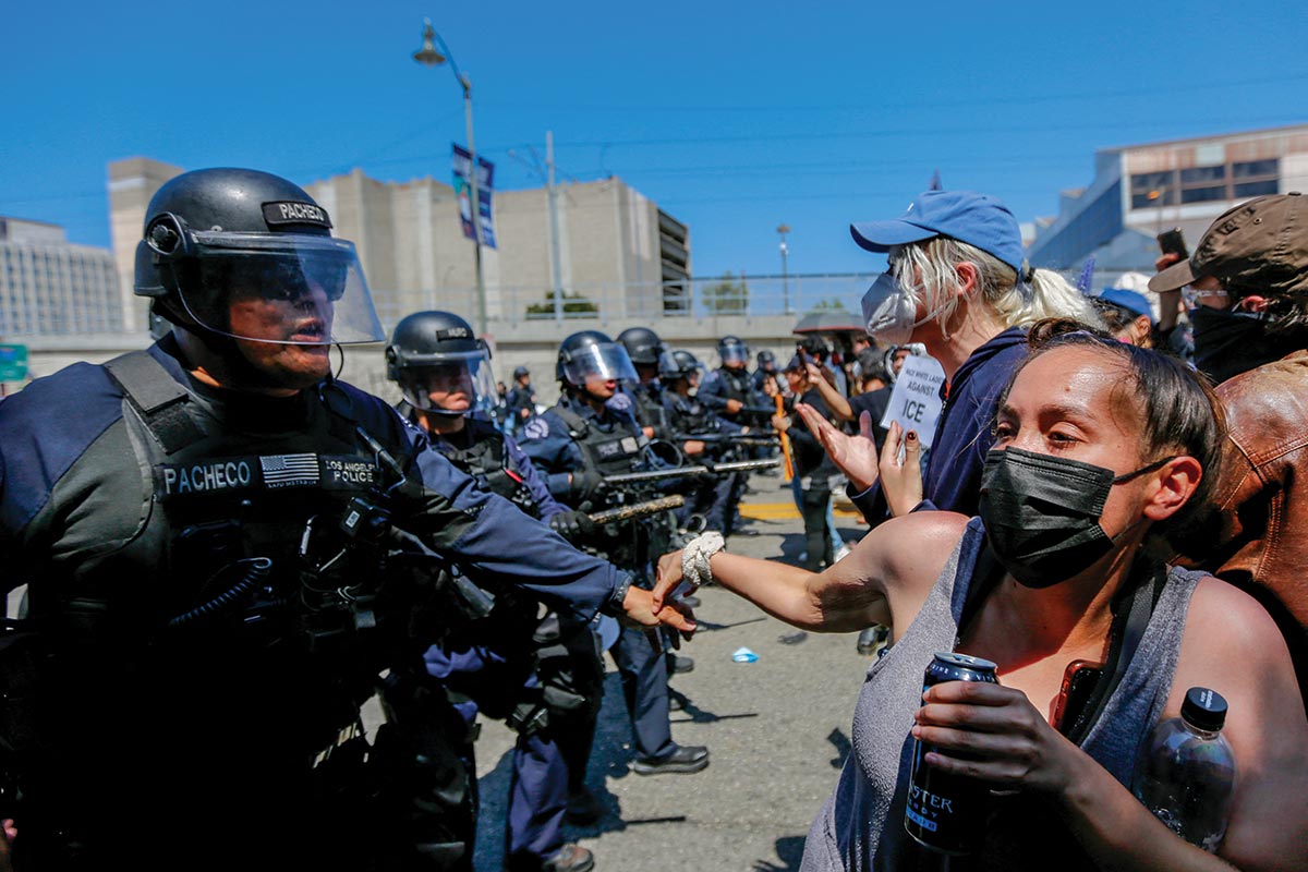 Protesters confronted LAPD officers during an anti-ICE protest in downtown Los Angeles on June 8, 2025, the day after federal immigration rais began.