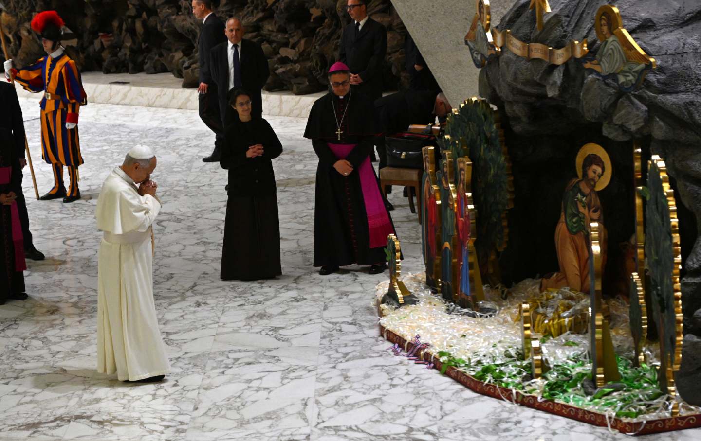Pope Leo XIV stands in front of a Christmas nativity scene at Paul-VI hall in the Vatican on December 15, 2025.