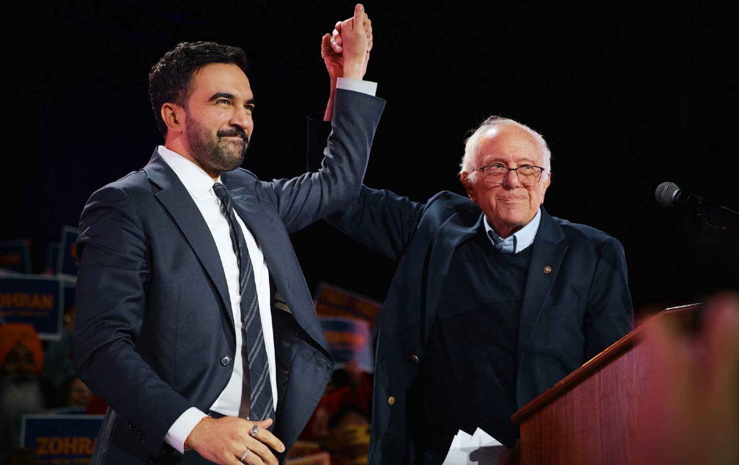 Mayor-elect Zohran Mamdani celebrates with Senator Bernie Sanders during an election rally with Sanders and US Representative Alexandria Ocasio-Cortez at Forest Hills Stadium on October 26, 2025, in Queens, New York.