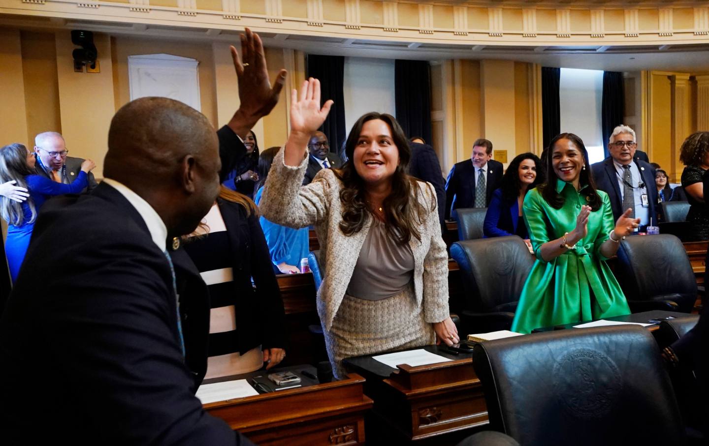 House Speaker Don Scott, D-Portsmouth, left, high fives Delegate Lily Franklin, D-Montgomery, center, after taking the oath of office during the opening of the 2026 session of the Virginia General Assembly.