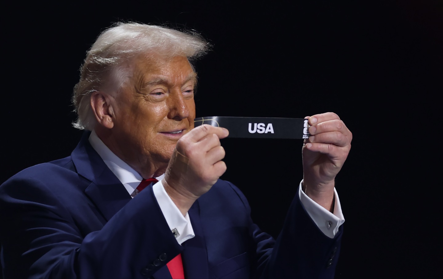 Donald Trump draws out the card of the United States during the FIFA World Cup 2026 Official Draw at John F. Kennedy Center for the Performing Arts on December 5, 2025, in Washington, DC.
