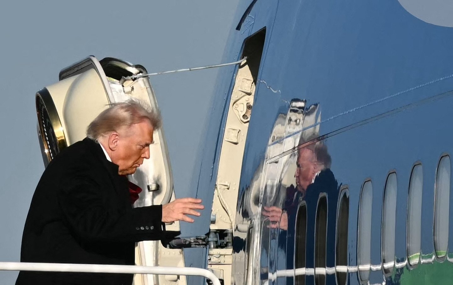 Donald Trump boards Air Force One before departing Detroit Metropolitan Wayne County Airport in Romulus, Michigan on January 13, 2026.