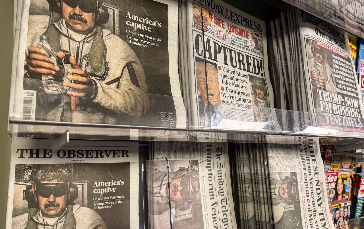 UK newspaper front pages display stories on the capture and arrest of President Nicolas Maduro from Venezuela in a newsagent shop, on January 4, 2026, in Somerset, England.
