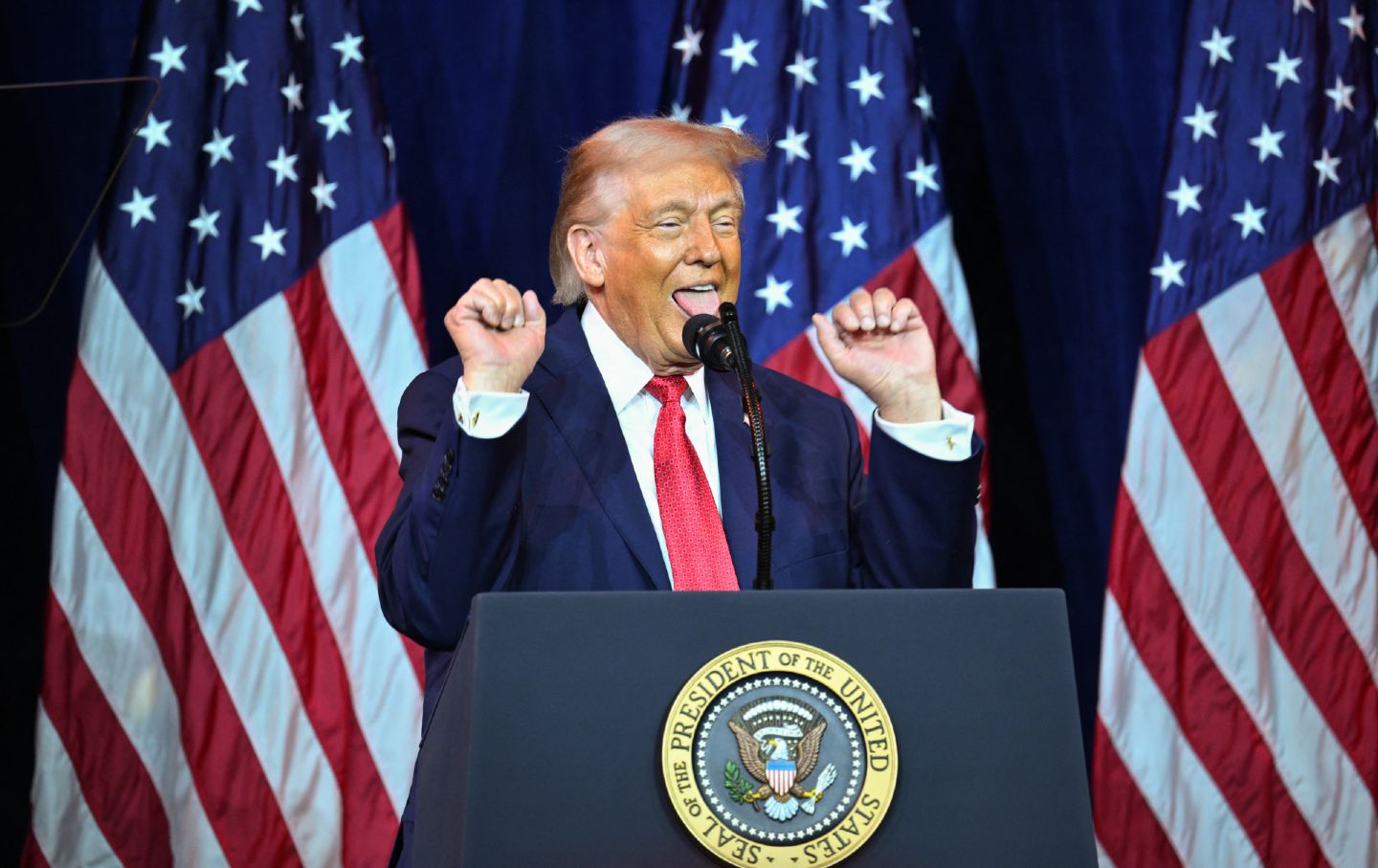 Donald Trump wringing hands around mouth during speech