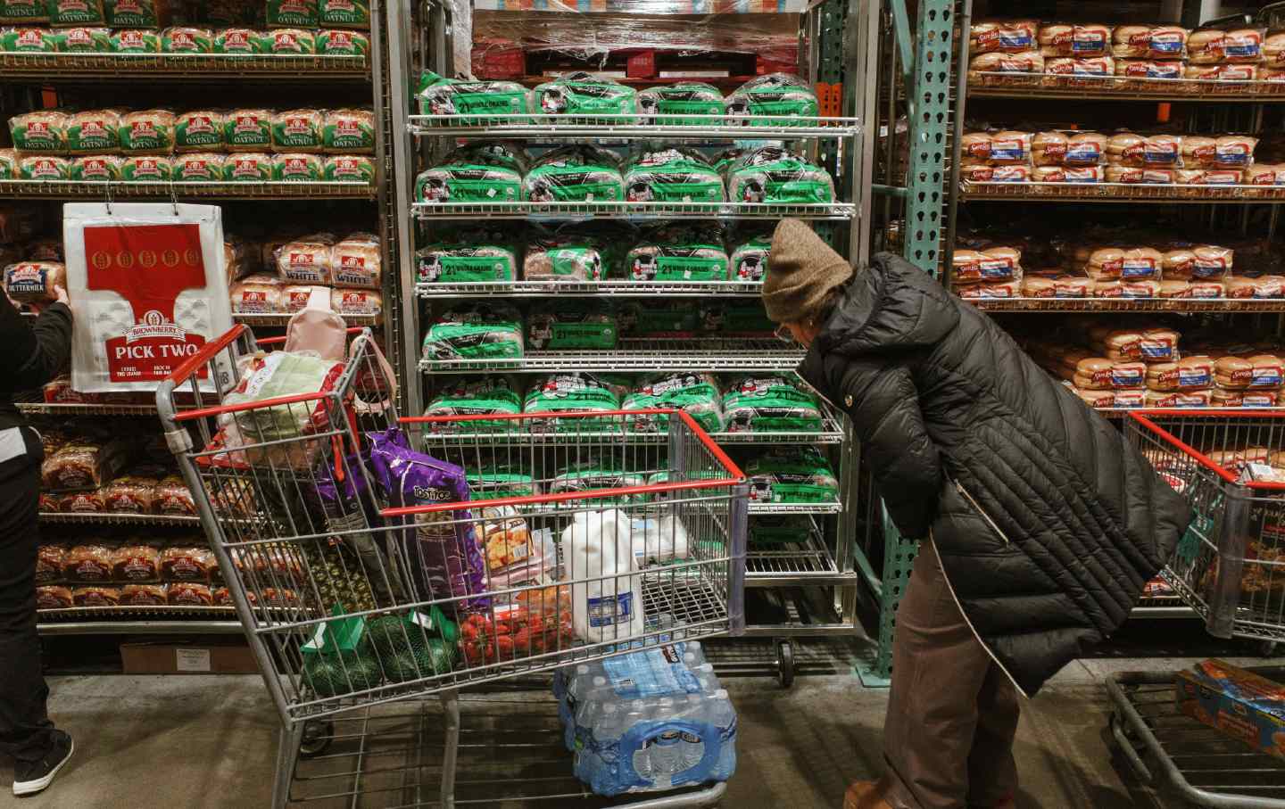 Shoppers browse the bread aisle at a grocery store on January 23, 2026. in Lenexa, Kansas. Bread prices have increased by more than a third since January 2020.