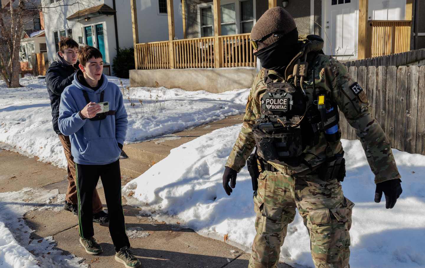 Border Patrol agents confront community members in a residential neighborhood in Minneapolis, Minnesota, on January 14, 2026.