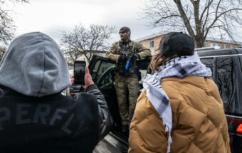 Minnesotans film a federal law enforcement agent during a patrol in Minneapolis, Minnesota, on January 11, 2026.