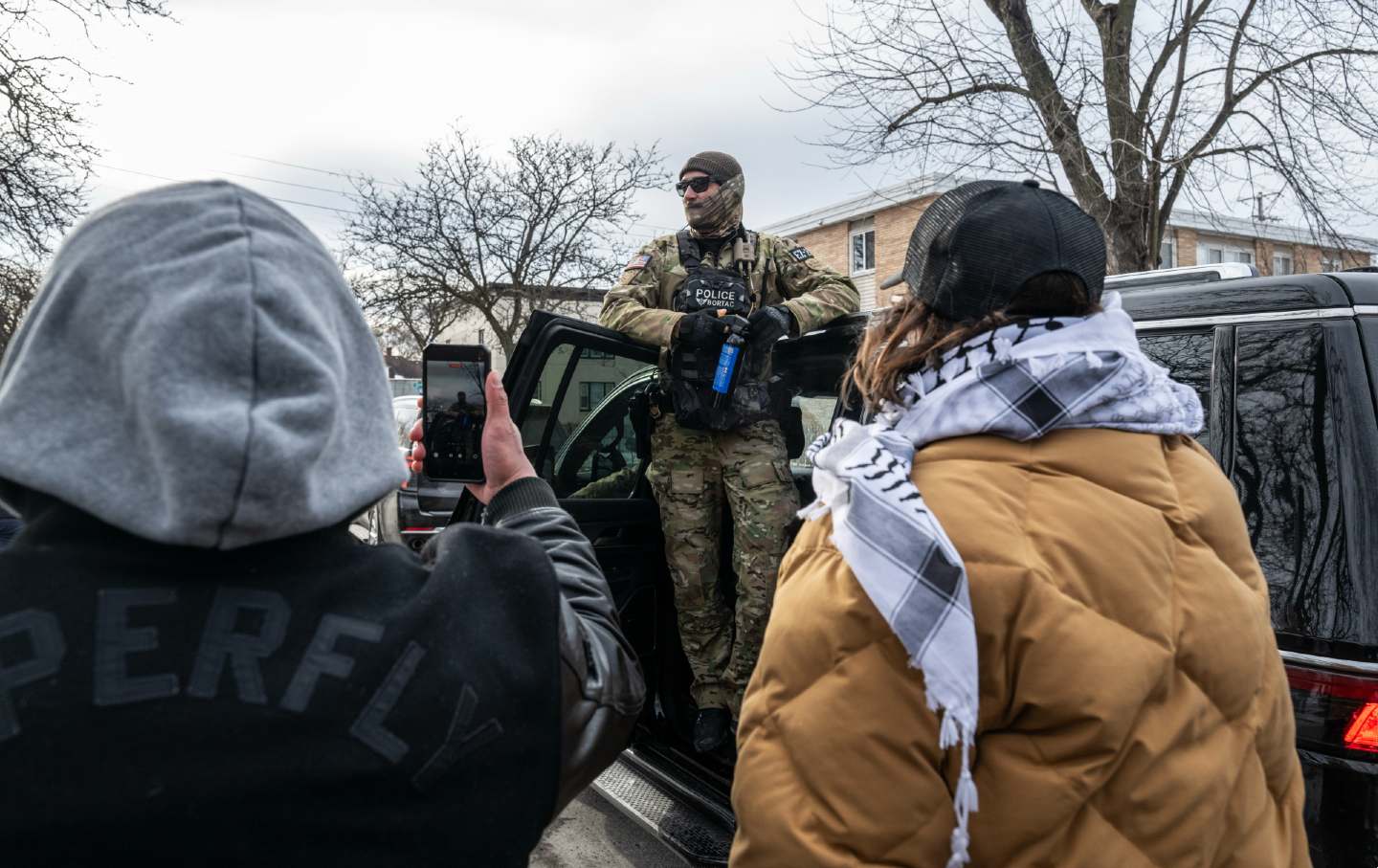 Minnesotans film a federal law enforcement agent during a patrol in Minneapolis, Minnesota, on January 11, 2026.