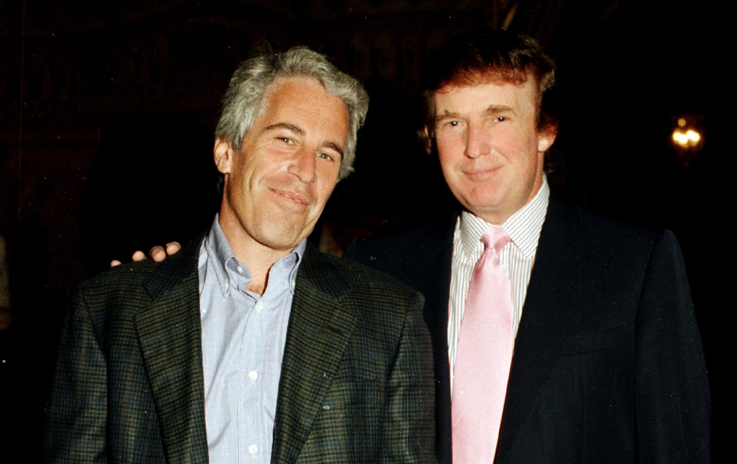 Jeffrey Epstein and Donald Trump pose together at the Mar-a-Lago estate, Palm Beach, Florida, on February 22, 1997.