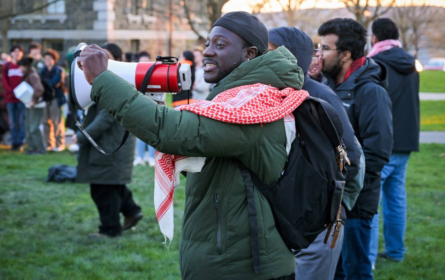 Momodou Taal, center, is pictured at a pro-Palestinian encampment at Cornell University in Ithaca, NY, Thursday, April 25, 2024.