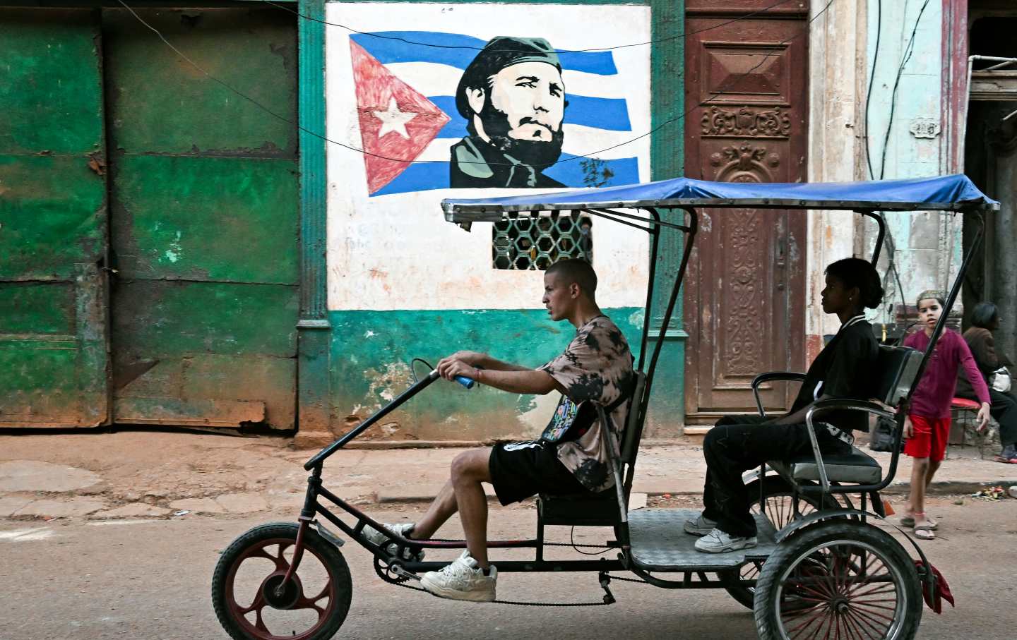 A bicitaxi rides along a street in Havana amid nationwide fuel shortages, on February 13, 2026.