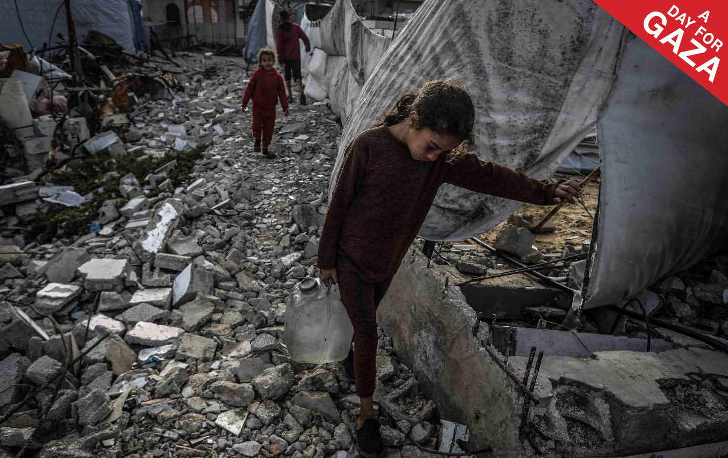 A Palestinian girl carries a gallon of drinking water she filled from a water truck in Khan Younis. Palestinians in Gaza are suffering from a severe water crisis due to the destruction of water wells by Israeli air strikes.