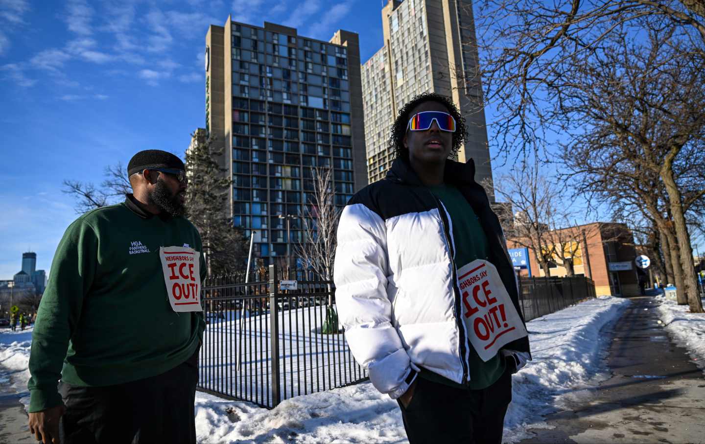 ICE watchers Mustafa Mohamed (L) and Mahad Ahmed patrol their community around the Riverside Plaza complex in the Cedar-Riverside neighborhood on January 9, 2026 in Minneapolis, Minnesota.