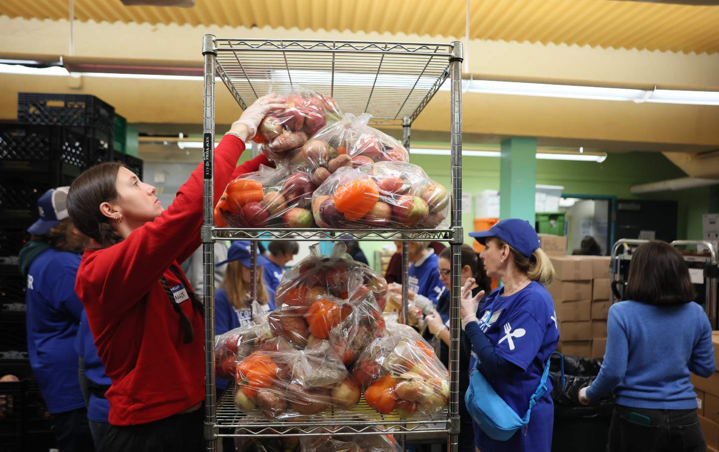 Volunteers with New York Common Pantry help to prepare food packages on October 30, 2025, in New York City.