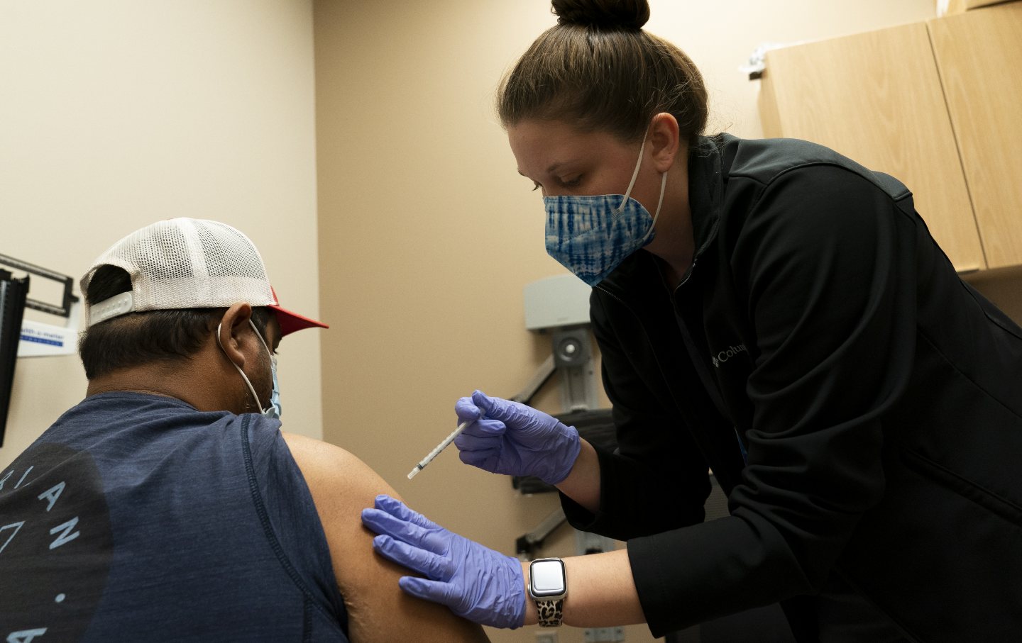 A healthcare worker administers a Covid-19 vaccine at an Oklahoma County Health Department Vaccine Clinic.
