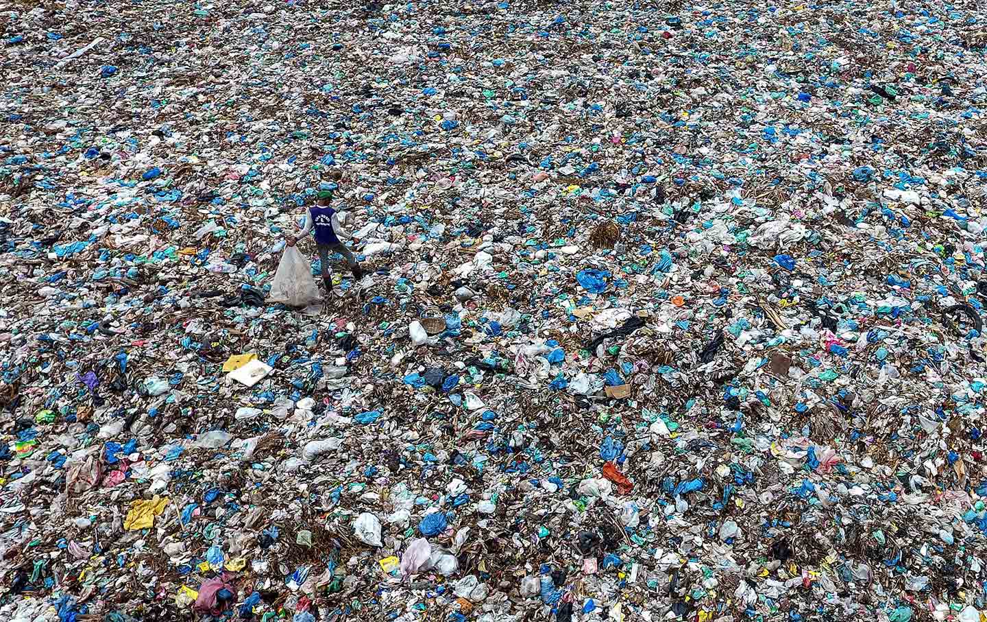 Looking for plastic bottle trash at a garbage dump in Aceh province, Indonesia.