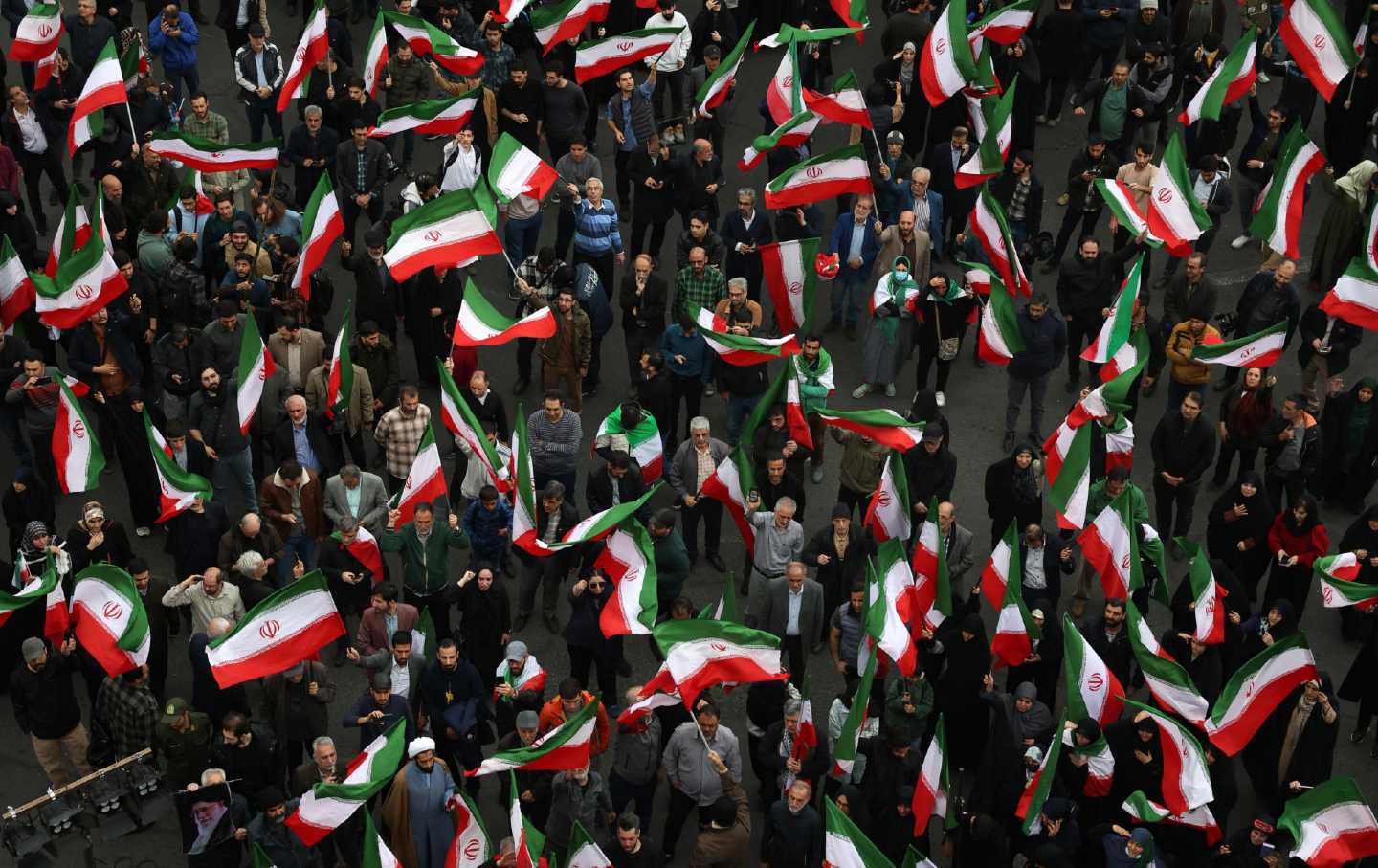 Iranians gather at Palestine Square in Tehran carrying Iranian flags, chanting anti-US and anti-Israel slogans to protest the attacks by the United States and Israel on February 28, 2026.