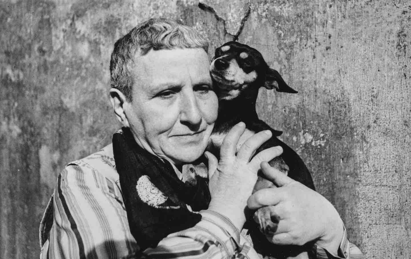 Gertrude Stein holding her dog Pepe, 1939.