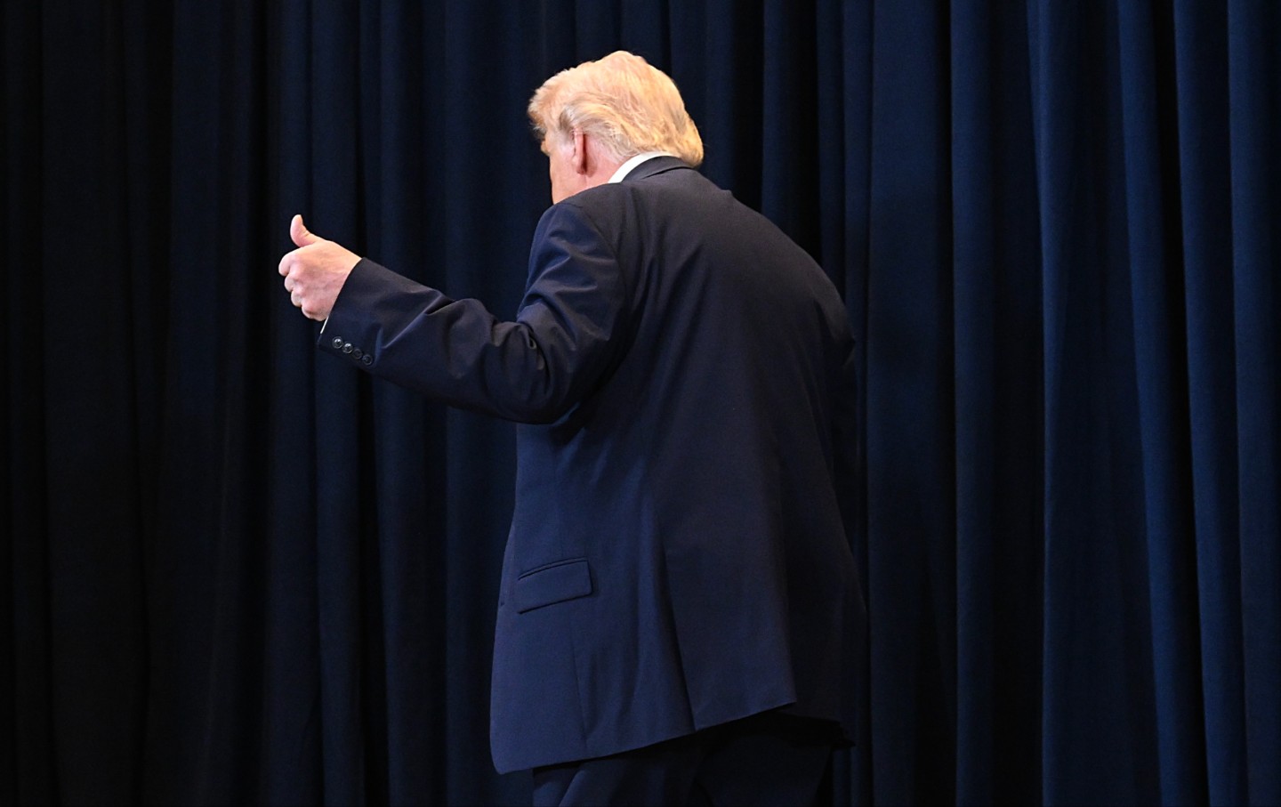 Donald Trump leave after speaking to reporters during a news conference at Trump National Doral Miami on March 9, 2026 in Doral, Florida.