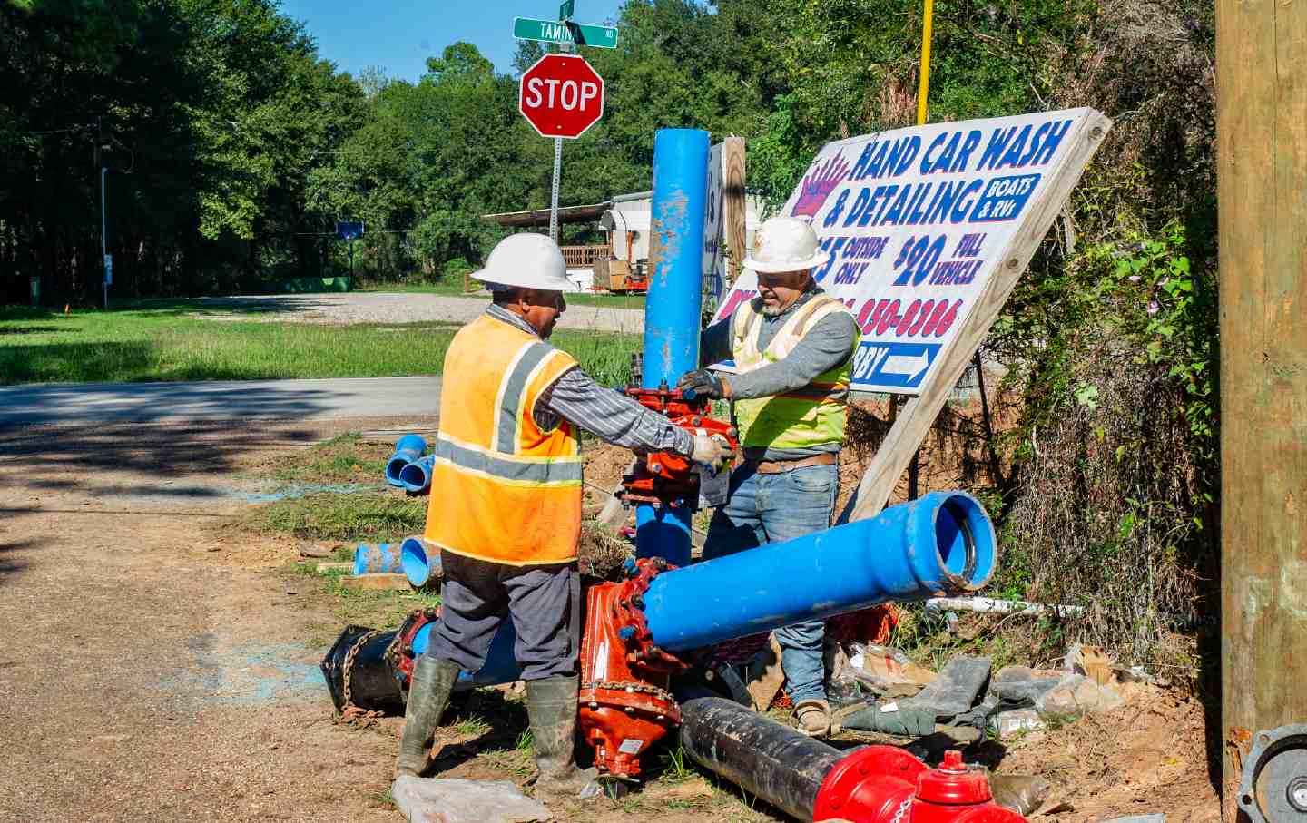 Construction workers work with pipes as part of Texas’s sewer project