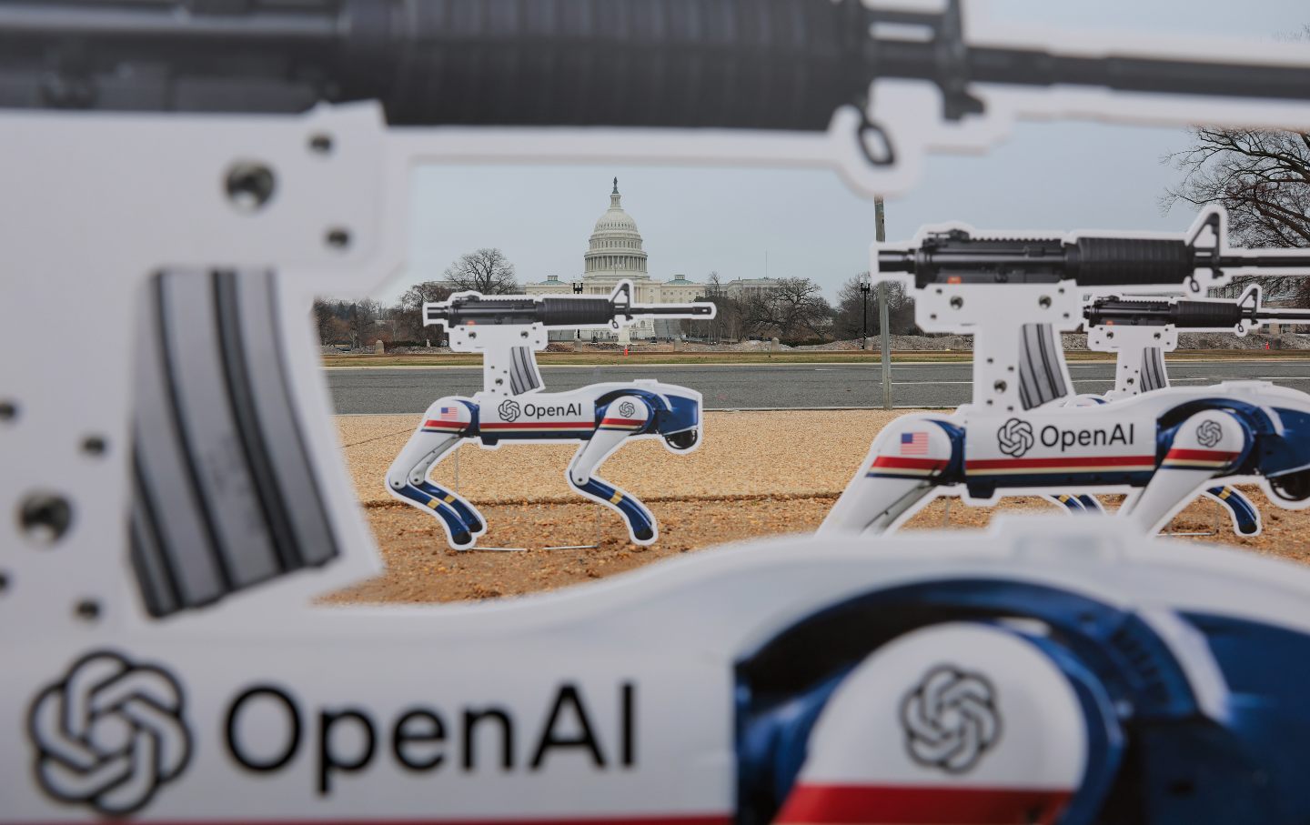 Activists place signs featuring AI robot dogs on the grounds of the National Mall to protest OpenAI's decision to allow the Pentagon to use its AI technologies in developing autonomous weapons, on March, 6, 2026.
