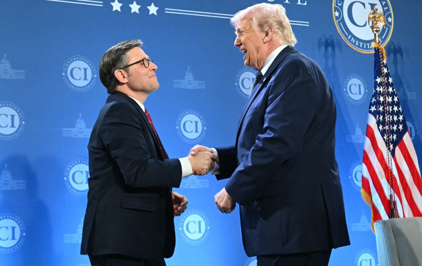 President Donald Trump shakes hands with Speaker of the House Mike Johnson during the Republican Members Issues Conference at Trump National Doral in Miami, Florida, on March 9, 2026.