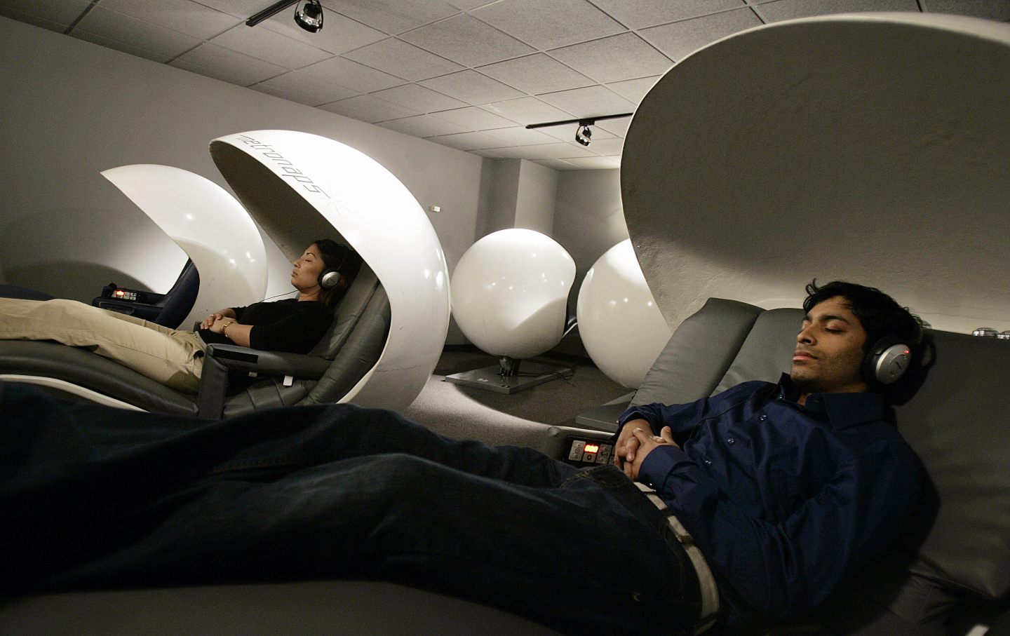 Employees demostrate sleeping “pods” in a corporate office.