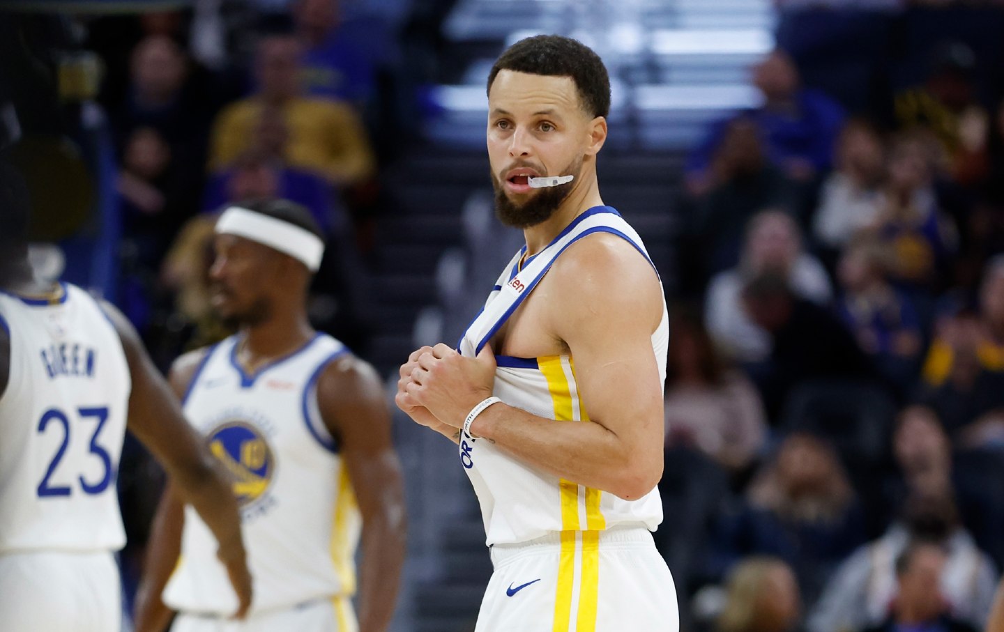 Stephen Curry of the Golden State Warriors tugs at his jersey in a game against the Atlanta Hawks on January 11, 2026, in San Francisco, California.