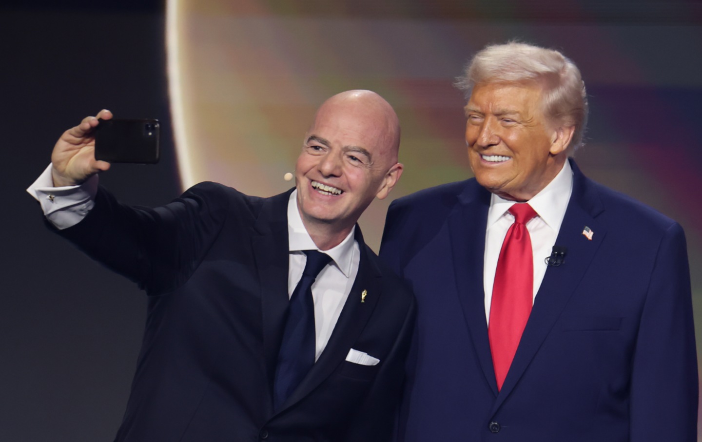 President Donald Trump poses for a selfie with Gianni Infantino, the president of FIFA, during the FIFA World Cup 2026 Official Draw on December 5, 2025, in Washington, DC.
