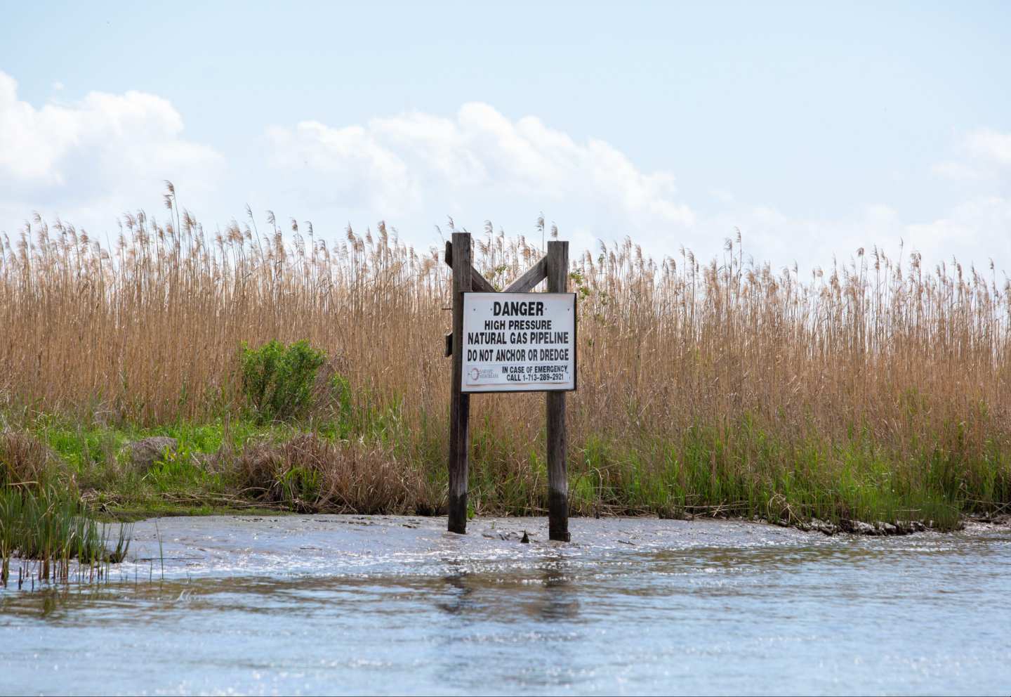 A sign warns of a natural gas pipeline on a canal north of Vermilion Bay on March 27, 2026.