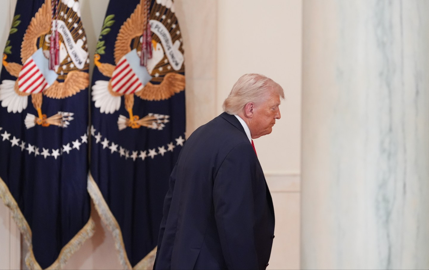 Donald Trump departs following a prime-time address to the nation in the Cross Hall of the White House, on April 1, 2026.