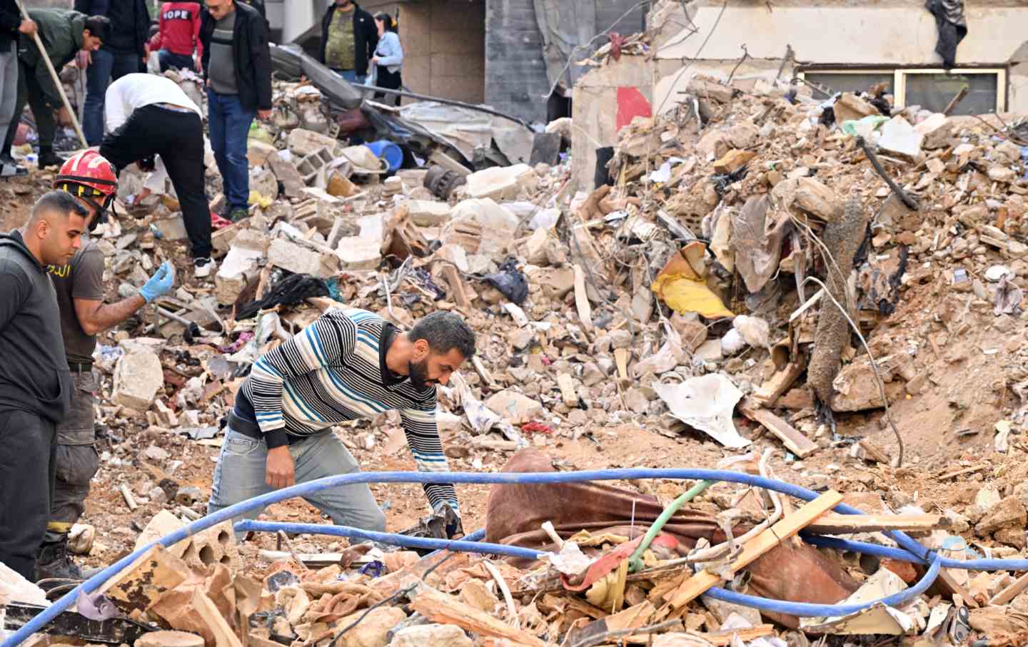 Ali Abbud, who lost three family members in simultaneous Israeli airstrikes on Lebanon on April 8, takes part in the search and rescue operations in hopes that his sister Zehra will be rescued from the rubble of a building hit in Beirut, Lebanon on April 12, 2026.