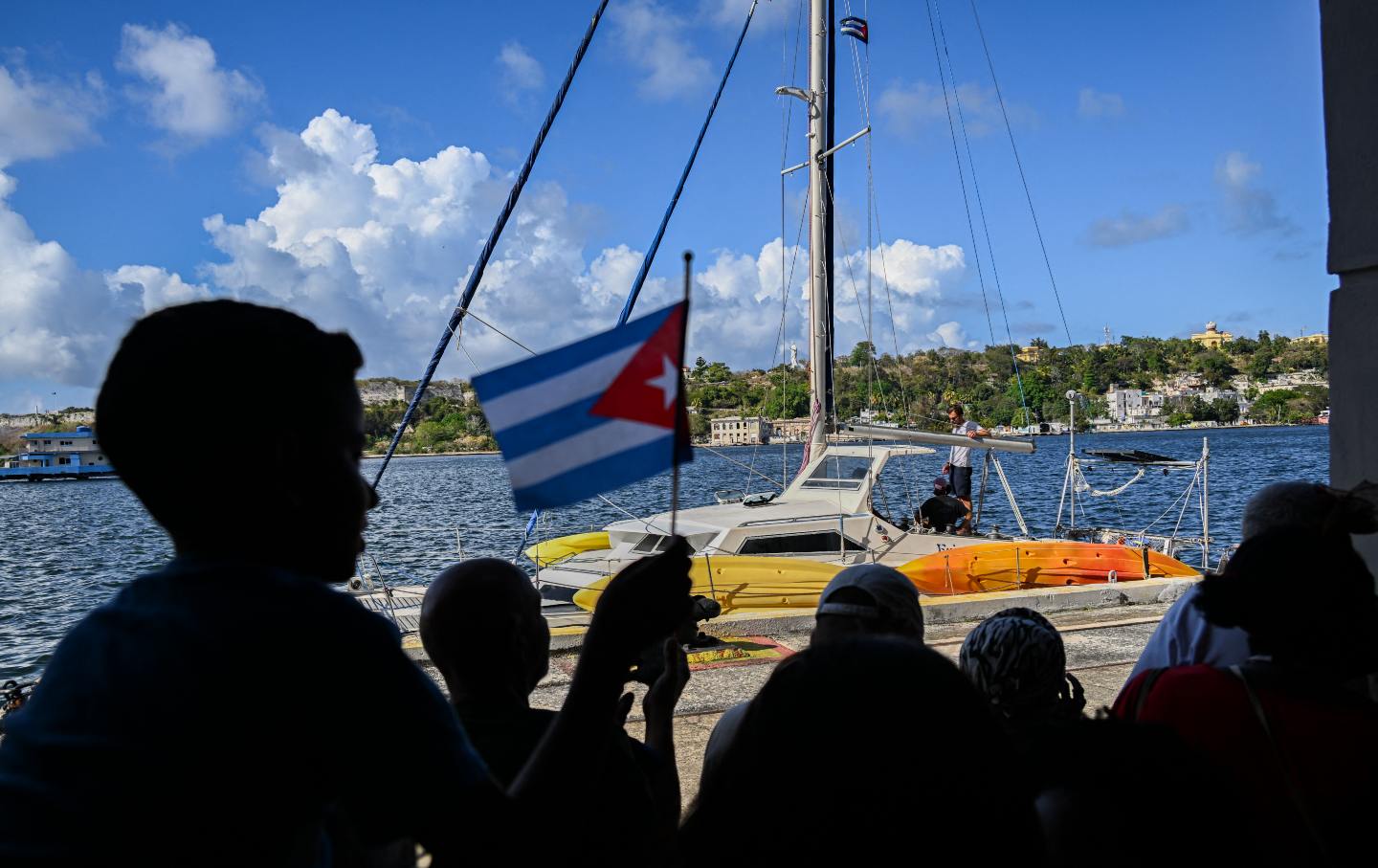 Cubans and international solidarity organizers look on as one of the two sailboats carrying humanitarian aid arrive in Havana, Cuba, on March 28, 2026.