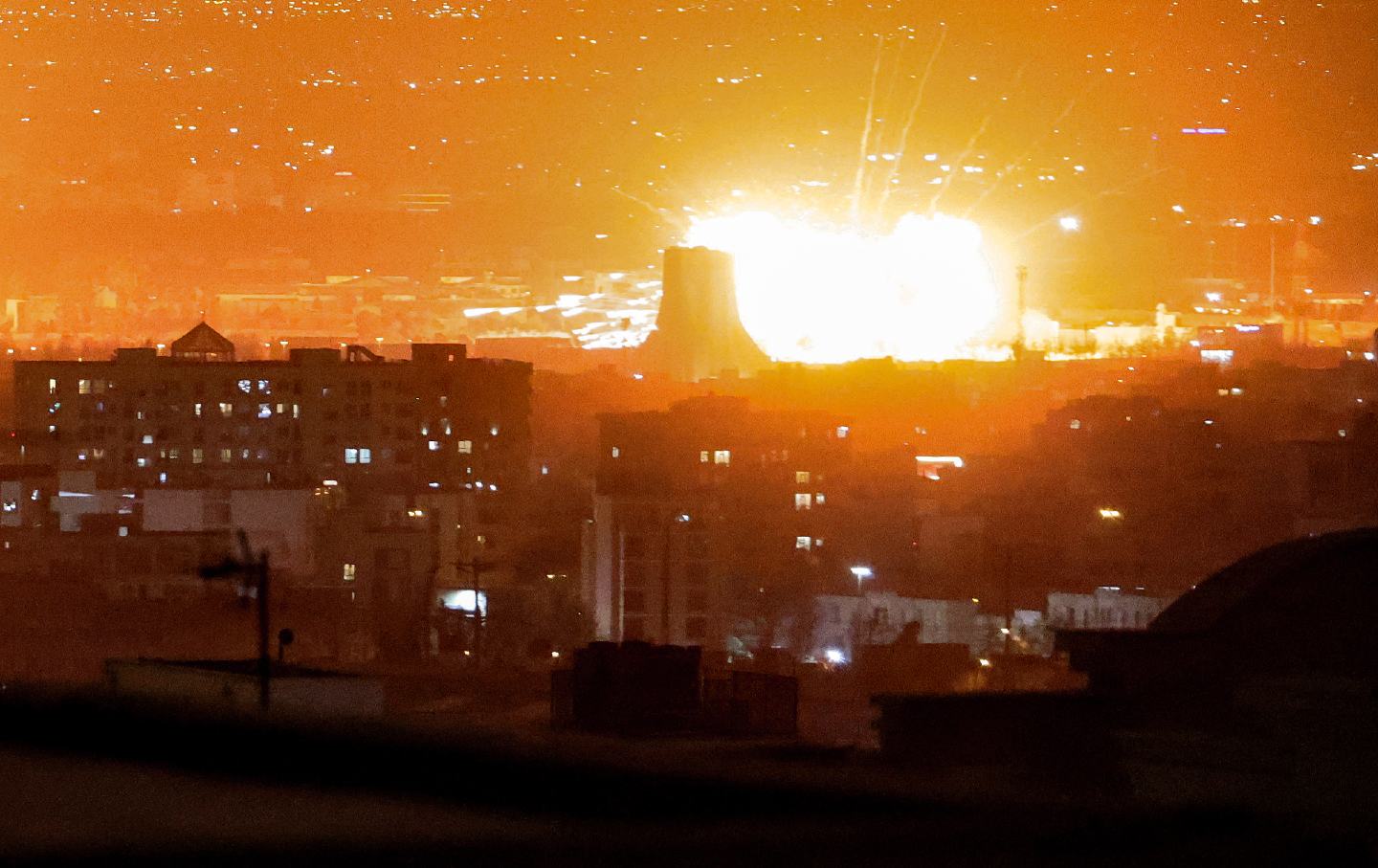 An explosion lights up the sky following US-Israeli strikes near Azadi Tower close to Mehrabad International Airport in Tehran on March 7, 2026.