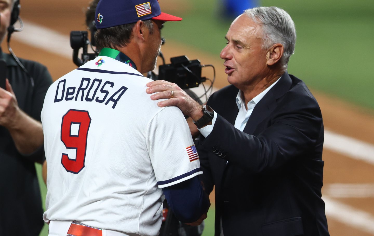 Anti-union MLB commissioner Rob Manfred shakes hands with Team United States manager Mark DeRosa following the game against Team Venezuela at loanDepot park in Miami, Florida, March 17, 2026.