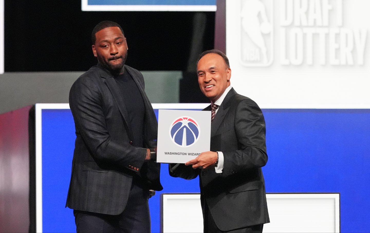 Washington Wizards' John Wall, left, and NBA Deputy Commissioner Mark Tatum, pose for photos after Tatum announced that the Wizards had won the first pick in the NBA basketball draft lottery in Chicago, Sunday, May 10, 2026.
