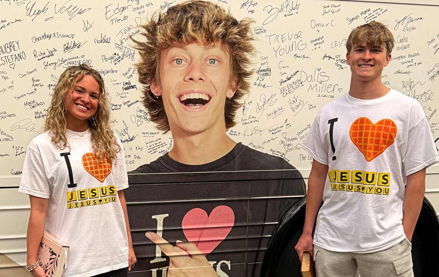Young Bryce Crawford fans posing in his “I Love Jesus” Waffle House merch.